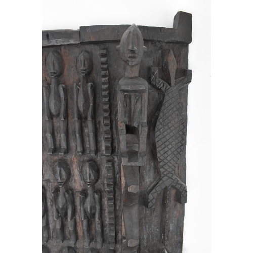 397 - A 20th century tribal African carved Dogon Granary  wood architectural door. The door carved in reli... 