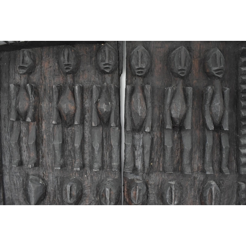 397 - A 20th century tribal African carved Dogon Granary  wood architectural door. The door carved in reli... 