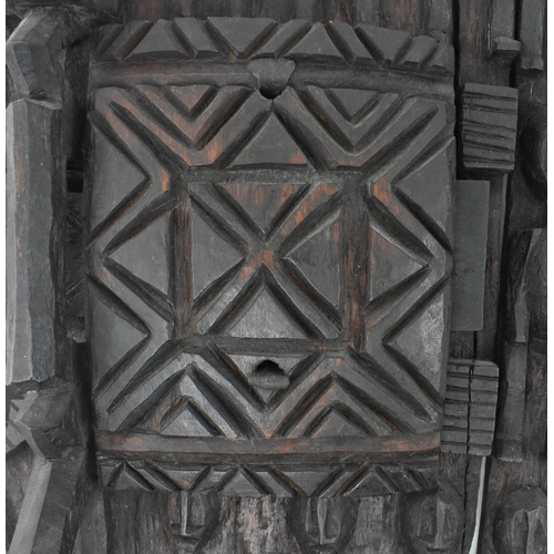 397 - A 20th century tribal African carved Dogon Granary  wood architectural door. The door carved in reli... 