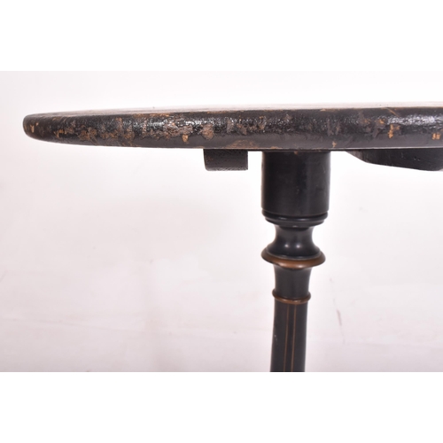 405 - A Napoleon III 19th century ebonised circular tilt top side table. The table having decorative flora... 