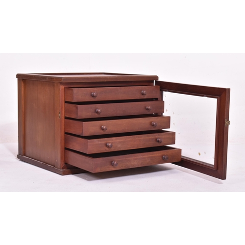 406 - An early 20th century mahogany glazed front watchmakers tools chest cabinet. The box having a recess... 