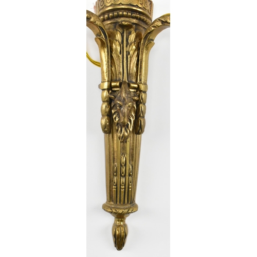 407 - A matching set of four 20th century gilt metal wall light sconces. Each with decorative urn and swag... 