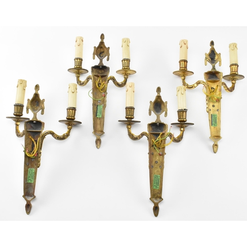 407 - A matching set of four 20th century gilt metal wall light sconces. Each with decorative urn and swag... 