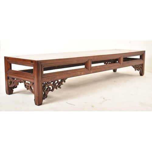 416 - A large Oriental Chinese influenced carved hardwood low occasional side table. The table having a re... 