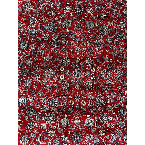 417 - A 20th century Islamic Sarouk Bakhtiyar floor carpet rug. The rug having a central red ground panel ... 