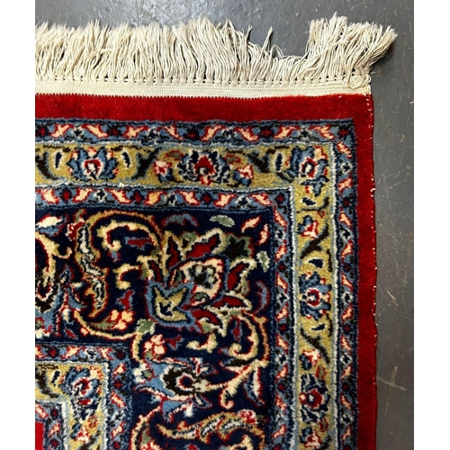 417 - A 20th century Islamic Sarouk Bakhtiyar floor carpet rug. The rug having a central red ground panel ... 