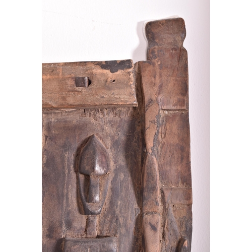 420 - An African Dogon Garnary Mali of three panels door. The door decorated with rows of figures, circula... 