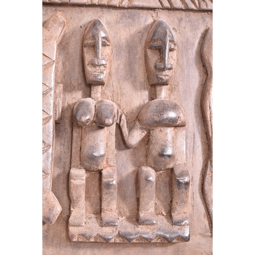 420 - An African Dogon Garnary Mali of three panels door. The door decorated with rows of figures, circula... 