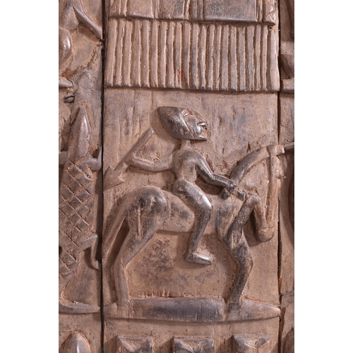 420 - An African Dogon Garnary Mali of three panels door. The door decorated with rows of figures, circula... 