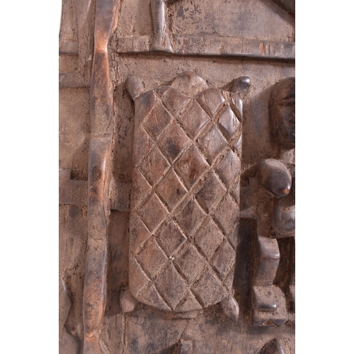 420 - An African Dogon Garnary Mali of three panels door. The door decorated with rows of figures, circula... 