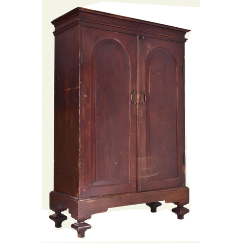 427 - A Anglo-Colonial 19th century campaign teak armoire wardrobe. The wardrobe a flared pediment atop ov... 