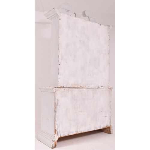 432 - A Victorian early 19th century white painted pine wood library bookcase. The bookcase having a scrol... 