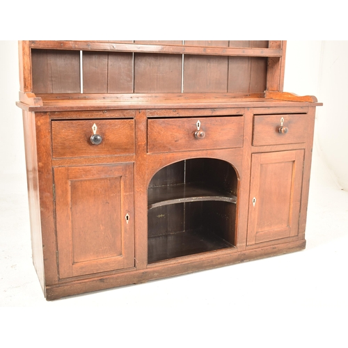 435 - A George III 18th century oak welsh Dog Kennel dresser. The dresser having a pediment top over a she... 