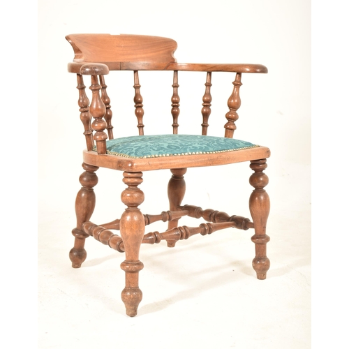 438 - A Victorian 19th century mahogany captain's smokers bow armchair. The chair having a shaped back sup... 