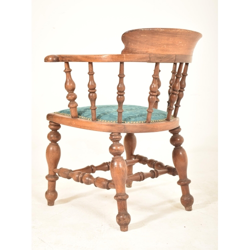 438 - A Victorian 19th century mahogany captain's smokers bow armchair. The chair having a shaped back sup... 