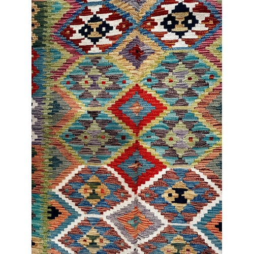 439 - A contemporary Anatolian Turkish Kilim floor carpet rug. The rug of rectangular form having an intri... 