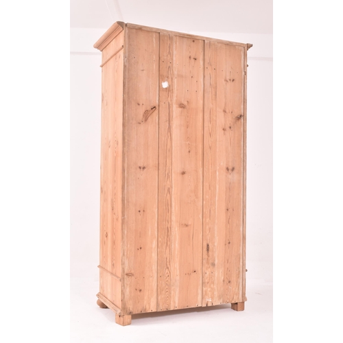 442 - A 20th century Scandinavian sentry box / pine single wardrobe armoire. The wardrobe being raised on ... 