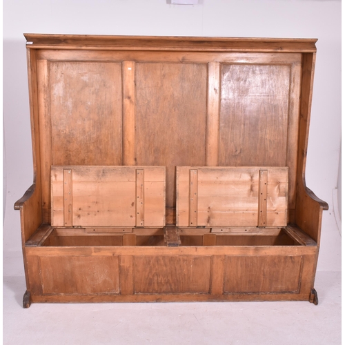 446 - A large Victorian 19th century pine box seat church ecclesiastic settle. The settle having canted co... 