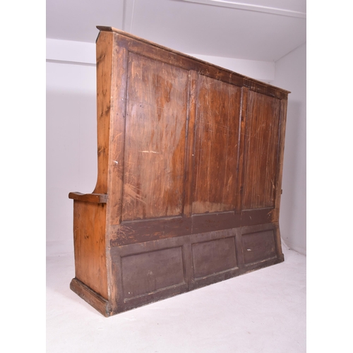 446 - A large Victorian 19th century pine box seat church ecclesiastic settle. The settle having canted co... 