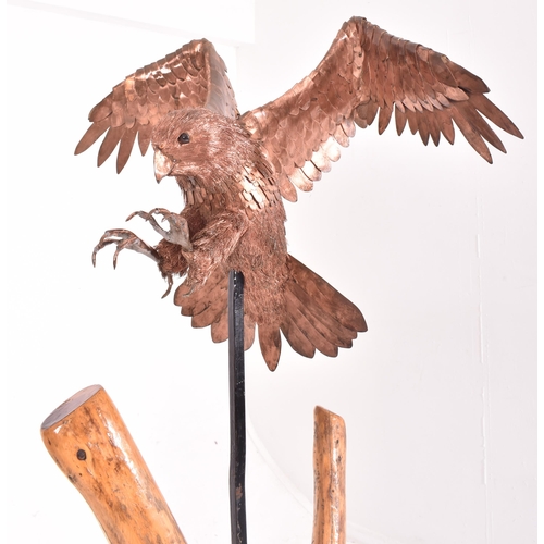 450 - Bob Rowley - A contemporary highly detailed copper layered worked sculpture depicting a life size Pe... 