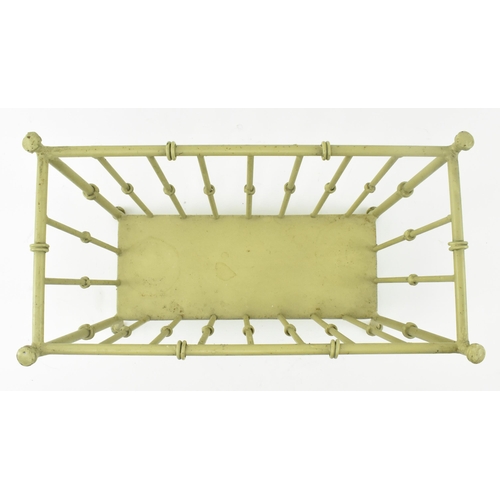 453 - An early 20th century painted wrought iron window planter / magazine rack. The planter with coil det... 