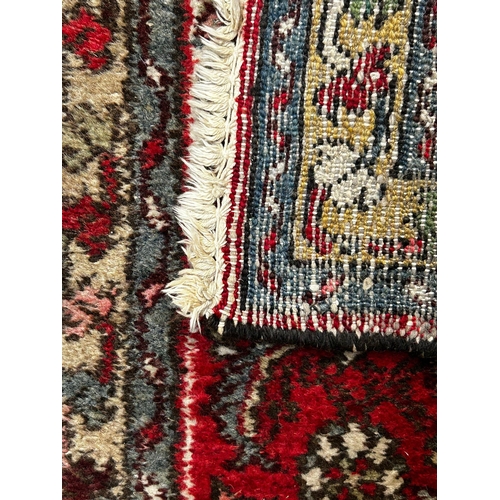 459 - An early 20th century Persian Islamic Bijar floor carpet runner rug. The runner having a red ground ... 