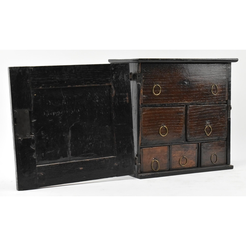 460 - A Commonwealth 17th century carved oak apprentice / spice cupboard chest. The chest having a carved ... 