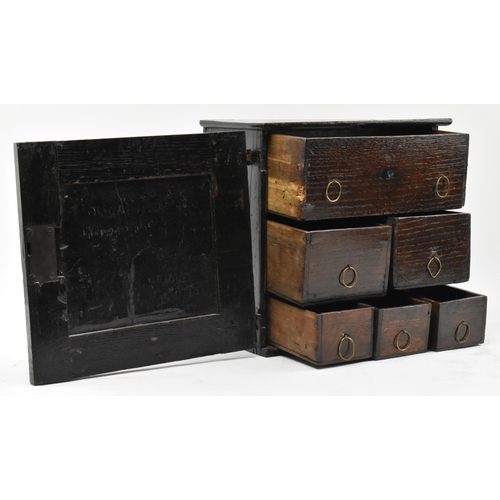 460 - A Commonwealth 17th century carved oak apprentice / spice cupboard chest. The chest having a carved ... 