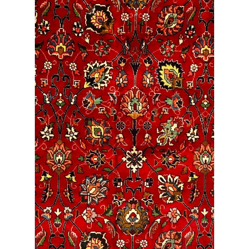 478 - A 20th century North West Persian Islamic Tabriz floor carpet rug. The rug having a central red grou... 