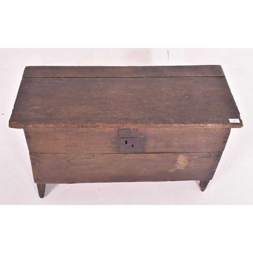 483 - A 17th century oak six plank coffer. The coffer having a hinged top with loop and wire hinges. Metal... 