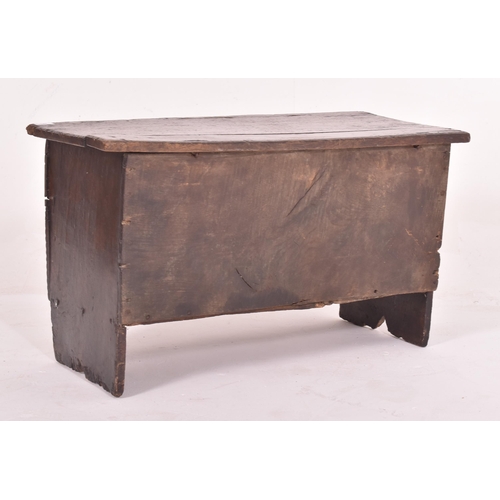 483 - A 17th century oak six plank coffer. The coffer having a hinged top with loop and wire hinges. Metal... 