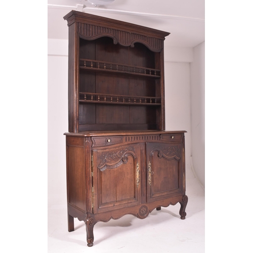 485 - A 19th century French provincial carved oak dresser. The dresser having a slender upright rack with ... 