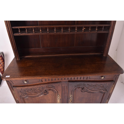 485 - A 19th century French provincial carved oak dresser. The dresser having a slender upright rack with ... 