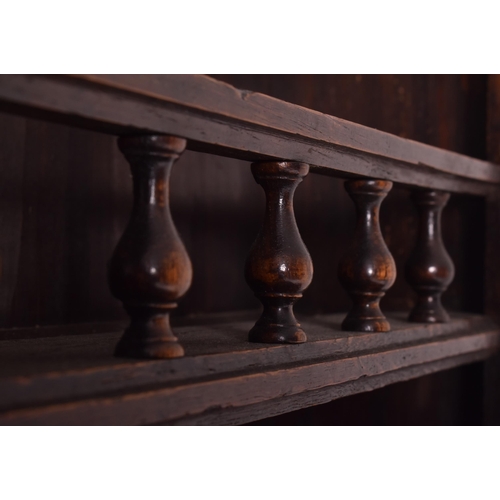 485 - A 19th century French provincial carved oak dresser. The dresser having a slender upright rack with ... 