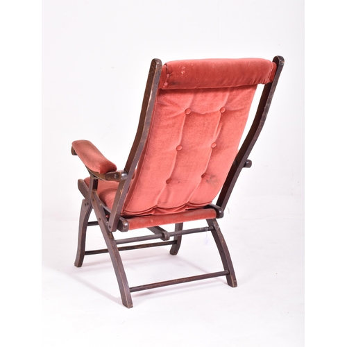 486 - A Victorian reclining and folding campaign / steamer chair. The arms of the reclining chair fitted w... 