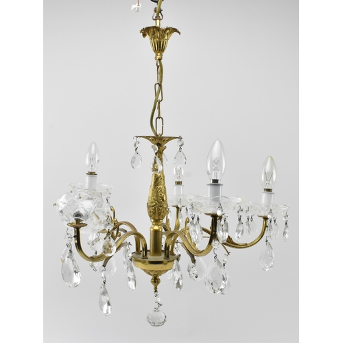 491 - A 20th century gilt metal and glass hanging ceiling light chandelier. The five arm chandelier having... 