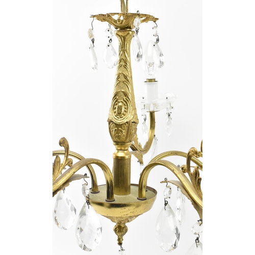 491 - A 20th century gilt metal and glass hanging ceiling light chandelier. The five arm chandelier having... 