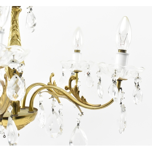 491 - A 20th century gilt metal and glass hanging ceiling light chandelier. The five arm chandelier having... 