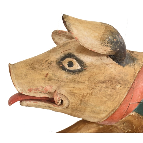 497 - A 20th century carved wooden fairground / carousel style figure of a pig. The pig with original hand... 