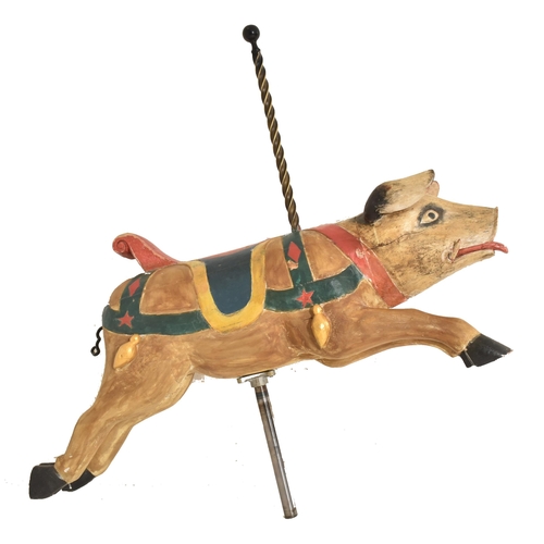 497 - A 20th century carved wooden fairground / carousel style figure of a pig. The pig with original hand... 