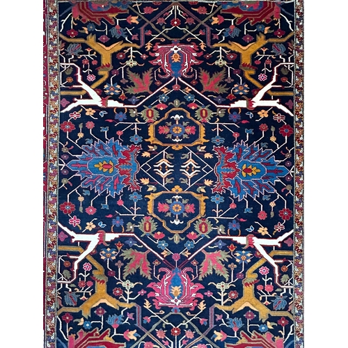 499 - A contemporary Persian Islamic Heriz fine wool floor carpet rug. The rug of rectangular form with ce... 