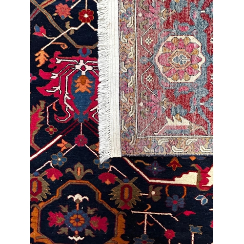 499 - A contemporary Persian Islamic Heriz fine wool floor carpet rug. The rug of rectangular form with ce... 