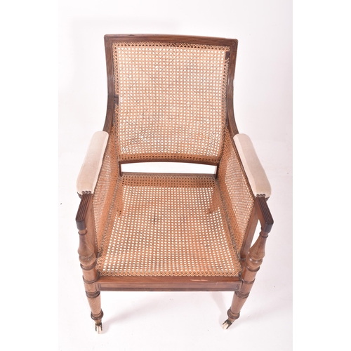 500 - A 19th century mahogany framed bergere library armchair in the manner of Gillows. The chair having a... 