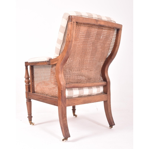 500 - A 19th century mahogany framed bergere library armchair in the manner of Gillows. The chair having a... 