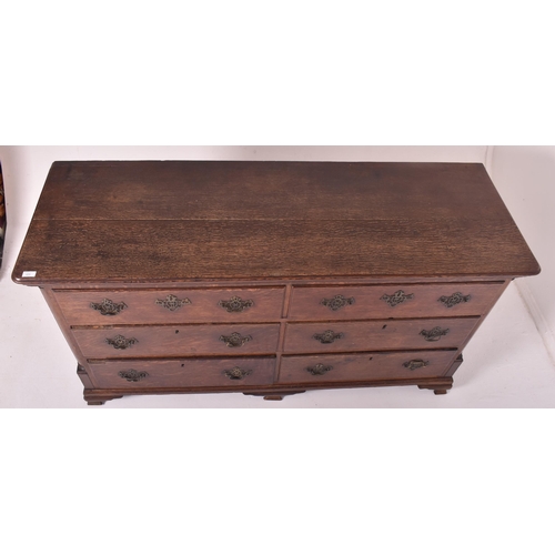 505 - A George III 18th century oak mule chest of drawers. The chest having a flared chamfered edge rectan... 