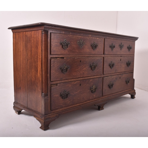 505 - A George III 18th century oak mule chest of drawers. The chest having a flared chamfered edge rectan... 