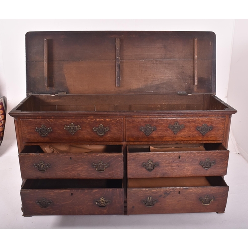 505 - A George III 18th century oak mule chest of drawers. The chest having a flared chamfered edge rectan... 