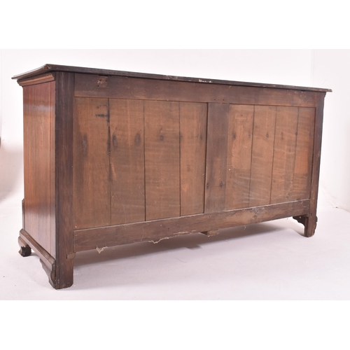 505 - A George III 18th century oak mule chest of drawers. The chest having a flared chamfered edge rectan... 