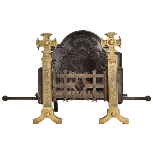 514 - A late 19th century / early 20th century cast iron fire grate and brass andirons. The fire set compr... 