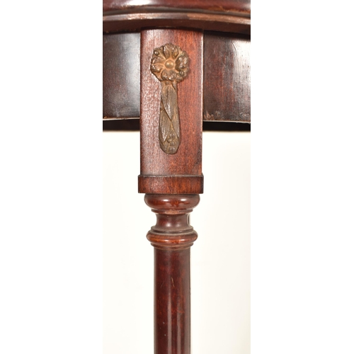 523 - A Biedermeier continental 19th century mahogany torchere / plant stand. The stand having a circular ... 